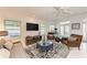 Bright living room featuring a modern ceiling fan, tv, and furniture with natural light, creating an inviting atmosphere at 160 Coolidge Dr, Sarasota, FL 34236