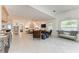 Open-concept living room with tile floors, neutral decor, and plenty of natural light at 160 Coolidge Dr, Sarasota, FL 34236