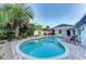 Private pool with lush tropical landscaping and comfortable seating area for relaxation and outdoor entertaining at 160 Coolidge Dr, Sarasota, FL 34236