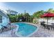 Backyard pool area with lounge chairs, a barbecue, and outdoor dining table at 160 Coolidge Dr, Sarasota, FL 34236