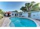 Backyard pool with comfortable lounge chairs, patio and an outdoor dining table at 160 Coolidge Dr, Sarasota, FL 34236