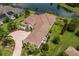 Beautiful aerial view of the home with tile roof, brick driveway, and manicured landscaping at 16531 Kendleshire Ter, Lakewood Ranch, FL 34202
