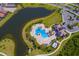 Aerial view of resort style pool, lake, landscaping, and community parking at 16531 Kendleshire Ter, Lakewood Ranch, FL 34202
