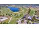Gorgeous aerial view of a golf course featuring a lake, clubhouse, and manicured greens at 16531 Kendleshire Ter, Lakewood Ranch, FL 34202