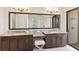 Elegant bathroom featuring double vanity, granite countertops, and a spacious glass-enclosed shower at 16531 Kendleshire Ter, Lakewood Ranch, FL 34202