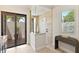 A walk-in shower with large glass panels and a bench is adjacent to the sliding door at 16531 Kendleshire Ter, Lakewood Ranch, FL 34202