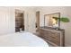 Comfortable bedroom featuring a decorative dresser and view to attached bath and entryway at 16531 Kendleshire Ter, Lakewood Ranch, FL 34202