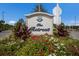 Community sign, The Retreat, surrounded by colorful flowers and landscaping under a blue sky at 16531 Kendleshire Ter, Lakewood Ranch, FL 34202