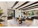 An open floor plan features a dining table with exposed wood beams and access to the kitchen at 16531 Kendleshire Ter, Lakewood Ranch, FL 34202