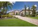 A beautiful single-story home featuring lush landscaping, a tile roof, and a paver driveway at 16531 Kendleshire Ter, Lakewood Ranch, FL 34202