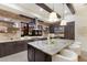Bright kitchen featuring a brick backsplash, stainless steel appliances, and a large island with granite countertops at 16531 Kendleshire Ter, Lakewood Ranch, FL 34202