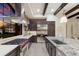 Contemporary kitchen with stainless appliances, granite countertops, and exposed brick accents and beams at 16531 Kendleshire Ter, Lakewood Ranch, FL 34202