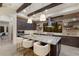 Stunning kitchen boasts exposed brick, wood beams, stainless appliances, and a center island with seating at 16531 Kendleshire Ter, Lakewood Ranch, FL 34202