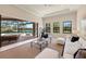 Bright living room featuring a pool view, with a seamless transition to the outdoor area through sliding glass doors at 16531 Kendleshire Ter, Lakewood Ranch, FL 34202