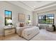 Spacious main bedroom with tray ceilings, two sitting areas, and large windows showing backyard views at 16531 Kendleshire Ter, Lakewood Ranch, FL 34202