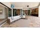Beautiful patio featuring comfortable seating, a TV, and a seamless transition to indoor living through sliding glass doors at 16531 Kendleshire Ter, Lakewood Ranch, FL 34202