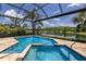 Sparkling pool with spa surrounded by lush landscaping and a serene lake view at 16531 Kendleshire Ter, Lakewood Ranch, FL 34202