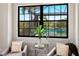 A bedroom sitting area with two chairs and a view of the backyard pool at 16531 Kendleshire Ter, Lakewood Ranch, FL 34202