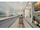 This home bar features white cabinets, a stainless mini refrigerator, and unique light fixtures at 1740 Alderman St # 7, Sarasota, FL 34236