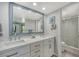 Bright bathroom features double sinks with an extra-large mirror and a convenient, glass-enclosed shower at 1740 Alderman St # 7, Sarasota, FL 34236