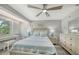 Bright bedroom with coastal decor, a ceiling fan, and a window view with a piano underneath at 1740 Alderman St # 7, Sarasota, FL 34236