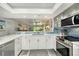 Modern kitchen with a breakfast bar, stainless steel appliances, and a view to the living area at 1740 Alderman St # 7, Sarasota, FL 34236