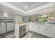 Bright kitchen boasts stainless steel appliances, a convenient laundry area, and a view into the living area at 1740 Alderman St # 7, Sarasota, FL 34236