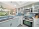 Open kitchen with stainless appliances and a breakfast bar offering a view to the living area at 1740 Alderman St # 7, Sarasota, FL 34236