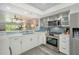 Open kitchen with stainless appliances and a breakfast bar offering a view to the living area at 1740 Alderman St # 7, Sarasota, FL 34236