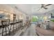 Living room offering a bar, seating area and private balcony with lush views at 1740 Alderman St # 7, Sarasota, FL 34236