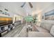 Open-concept living room with shiplap accent wall, stylish furnishings and bar access at 1740 Alderman St # 7, Sarasota, FL 34236