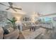 Comfortable living room with sectional sofa, decorative ceiling fans and views of the bar and kitchen area at 1740 Alderman St # 7, Sarasota, FL 34236