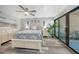 The bright main bedroom features a ceiling fan, wood floors, and sliding glass doors to the outdoors at 1740 Alderman St # 7, Sarasota, FL 34236