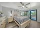 Relax in this lovely main bedroom with a ceiling fan, wood floors, and access to the balcony at 1740 Alderman St # 7, Sarasota, FL 34236