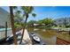 Scenic waterfront view with private dock, boat lift, pool, and lush tropical landscaping for tranquil coastal living at 1740 Alderman St # 7, Sarasota, FL 34236