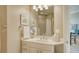 Bright bathroom featuring a vanity with marble countertop, decorative art, and recessed lighting at 1771 Ringling Blvd # 1206, Sarasota, FL 34236