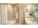 Cozy bathroom featuring a shower and tub combination, vanity, and decorative art at 1771 Ringling Blvd # 1206, Sarasota, FL 34236