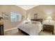 Inviting bedroom with a queen bed, side tables, and ample natural light from a window with blinds at 1771 Ringling Blvd # 1206, Sarasota, FL 34236