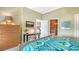 Serene bedroom with a woven bed, a sleek desk, a modern dresser, and glimpses of the en-suite bathroom at 1771 Ringling Blvd # 1206, Sarasota, FL 34236