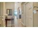 Hallway with tile flooring leading to the living area with an ocean view and a table with a mirror at 1771 Ringling Blvd # 1206, Sarasota, FL 34236