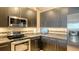 Kitchen featuring stainless steel appliances, dark cabinets and granite countertops at 1771 Ringling Blvd # 1206, Sarasota, FL 34236