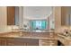 Kitchen featuring granite countertops and stainless steel appliances with an island overlooking the living area at 1771 Ringling Blvd # 1206, Sarasota, FL 34236