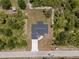 Aerial view of home showcasing landscaping, large lot, new roof, and driveway at 19185 Sherbrooke Ave, Port Charlotte, FL 33954