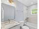 Bright bathroom featuring a bathtub with tiled walls, updated fixtures, and modern vanity with sink at 19185 Sherbrooke Ave, Port Charlotte, FL 33954