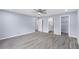 This is the home's primary bedroom, featuring wood floors and an ensuite bathroom and walk-in closet at 19185 Sherbrooke Ave, Port Charlotte, FL 33954