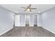This bedroom features wood floors and access to an ensuite bathroom and a walk-in closet at 19185 Sherbrooke Ave, Port Charlotte, FL 33954