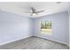 Inviting bedroom with hard surface flooring and a window with a view of the outdoors at 19185 Sherbrooke Ave, Port Charlotte, FL 33954