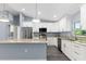 Modern kitchen with granite countertops, stainless steel appliances, and a large island with breakfast bar at 19185 Sherbrooke Ave, Port Charlotte, FL 33954