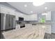 Bright kitchen featuring granite countertops, stainless steel appliances, and white cabinetry at 19185 Sherbrooke Ave, Port Charlotte, FL 33954