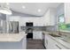 Bright kitchen featuring stainless steel appliances, granite countertops, and plenty of cabinet space at 19185 Sherbrooke Ave, Port Charlotte, FL 33954